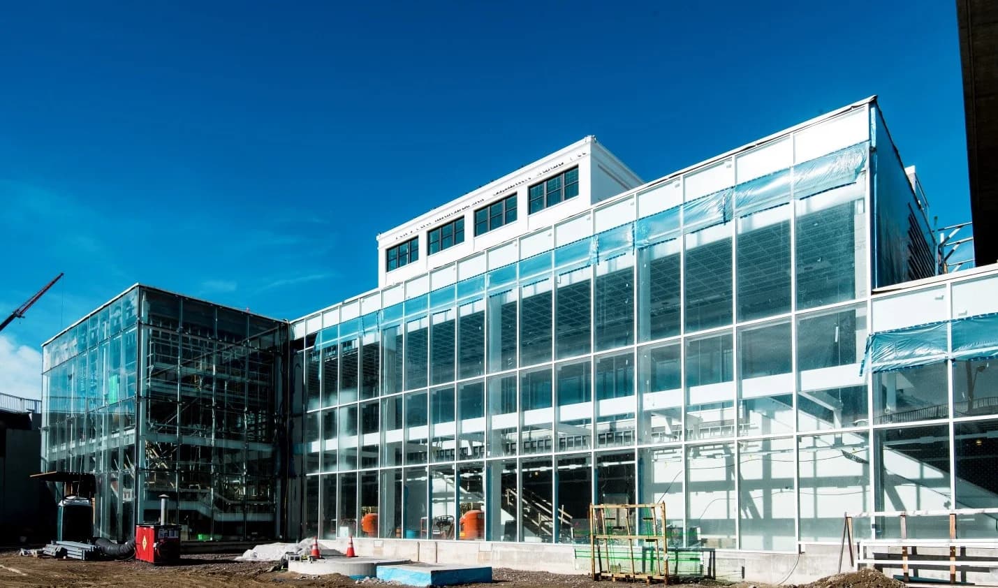 Glass-fronted Eglinton Crosstown station building during construction.